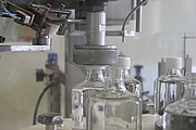 Stuffed transparent drug bottles are sealed by an automatic Capping.